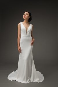 Bride wearing deep-V cut white crepe wedding dress