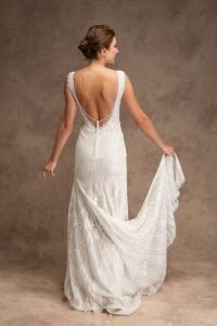 Back of bride wearing an ivory art deco wedding dress with a back opening with buttons