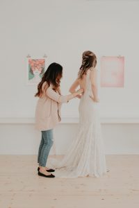 trying on a wedding gown, fitted low back sequin wedding gown