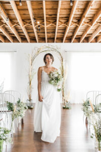 bride walking down aisle in chiffon wedding dress loft style wedding