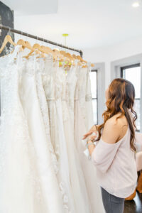 bride browsing wedding dress racks