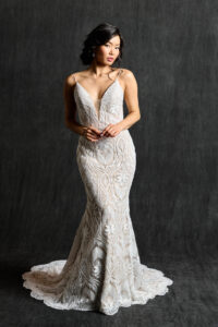 Lace boho sheath wedding gown with deep-V neckline, showcasing its intricate design and elegant style.