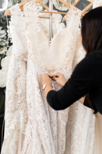 blush wedding dress on a rack
