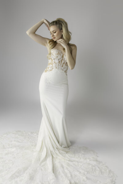 Corset bodice bridal gown. Floral lace, crepe fabric skirt, scalloped lace train. Clear sequin detail.