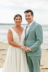 V neck crepe wedding dress full skirt on beach wedding groom in ocean green suit