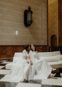 two brides sitting on a couch