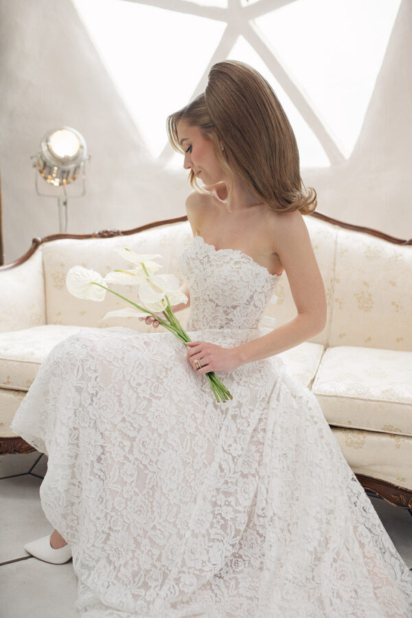 strapless lace wedding dress; vintage inspired lace, blush undertones, basque waist. Sitting bride